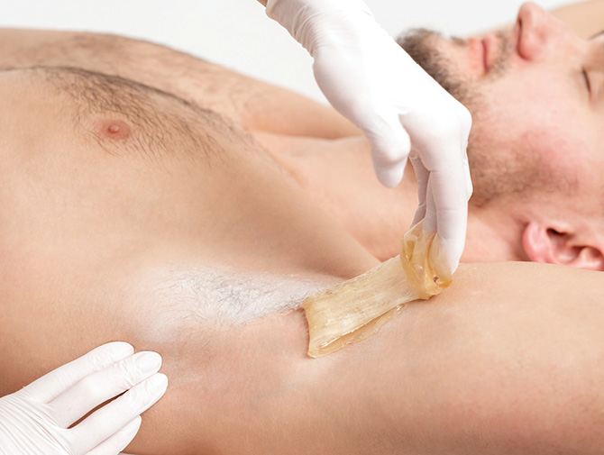 Man having his underarms and chest waxed